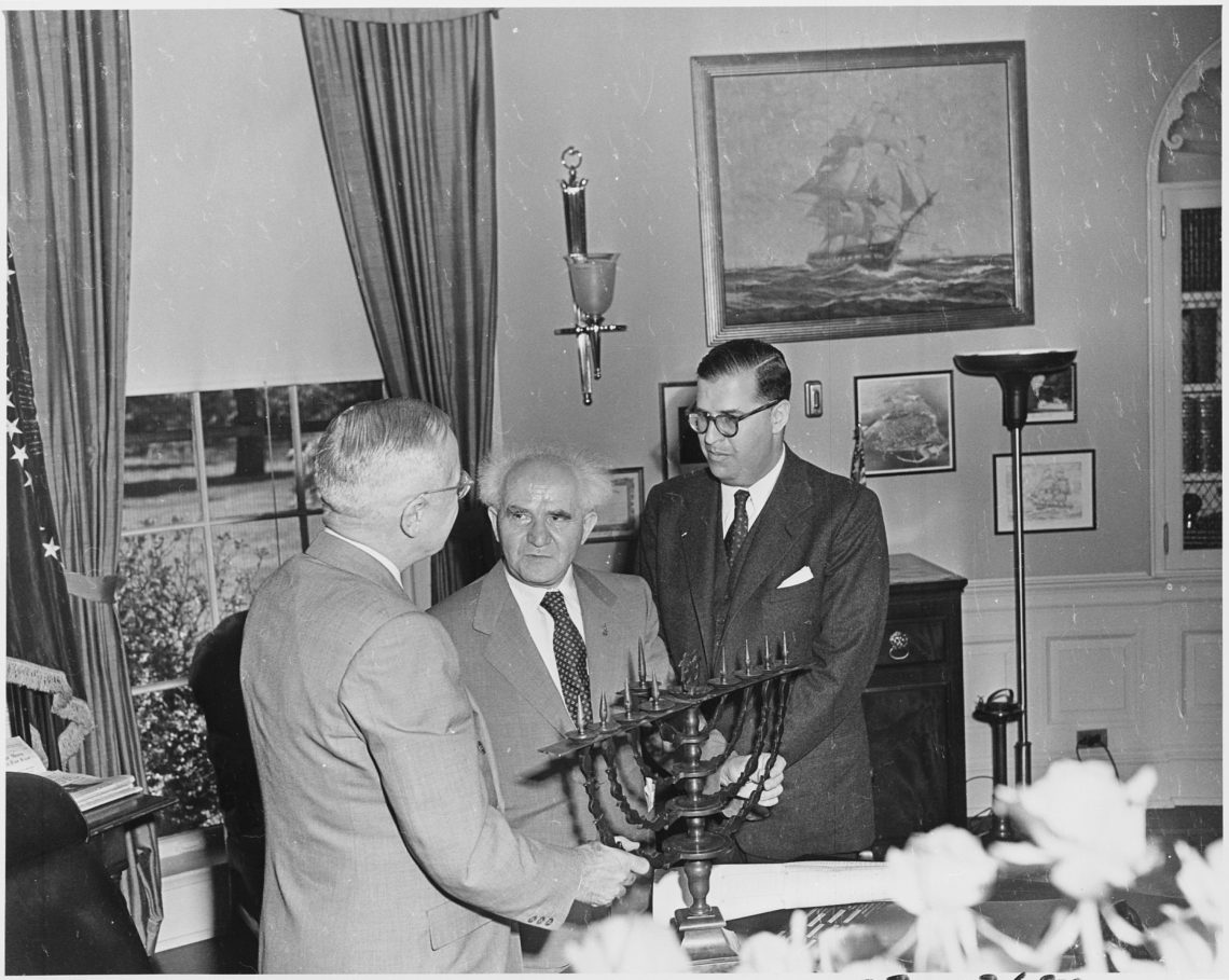 photo: President Truman receiving a Hanukkah menorah from Prime Minister David Ben-Gurion (center) and Abba Eban, Ambassador of Israel to the United States, in 1951. Photo courtesy of Wikimedia Commons